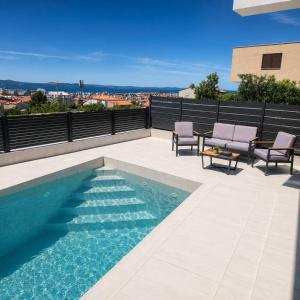 a swimming pool on the roof of a house at White Hills Villa in Zadar