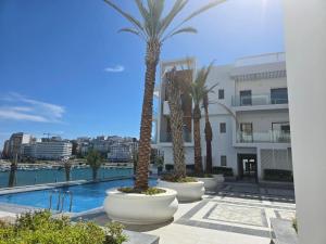 a row of palm trees inront of a building at Superbe appartement à marina Tanger in Tangier