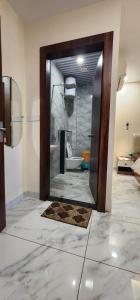 a bathroom with a shower with a toilet and a mirror at Pratap Royal Stay in Ujjain +24 photos
