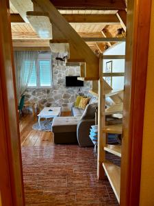 a living room with a couch and a staircase at Apartman Djina Zabljak in Žabljak