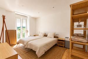a bedroom with a large bed and a large window at Rivera de Poulo in Ordes