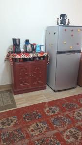 a kitchen with a stove and a refrigerator at Tahiti North coast kilo 62 in Borg El Arab