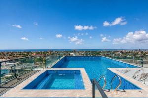 a swimming pool on top of a building at FLORIA - Sky Suites in Accra