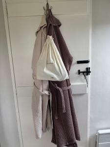 a rack of towels hanging on a door at The Annexe in Chipping Campden +42 photos