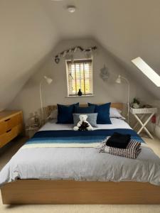 a bedroom with a large bed with a teddy bear on it at The Annexe in Chipping Campden