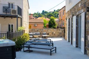 a patio with a bunch of chairs and a building at Gloria Holiday - Casa Bianca in Piran