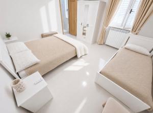 a bedroom with two beds and two chairs at Villa Daisy Conversano-Polignano a Mare in Conversano +60 photos