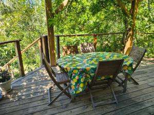 a table and two chairs on a deck with a table at Chambre privative in Lecci