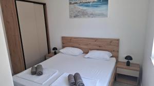 a bedroom with a bed with two shoes on it at Mima apartments in Povljana +33 photos