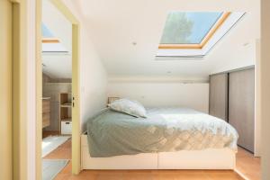a bedroom with a bed and a skylight at Maison de campagne in Aubagne