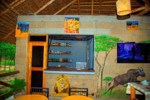 a restaurant with a lion painted on the wall at FRAPG camp and lodge in Mikumi