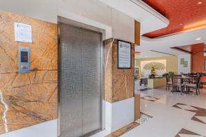 a lobby with a metal door in a building at Treebo Premium Raj Elegance Manyata Tech Park in Bangalore