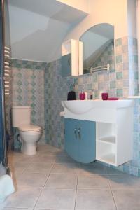 a bathroom with a sink and a toilet at Villa Magna in Gdynia