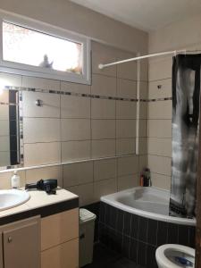 a bathroom with a tub and a sink at Villa Dream in Karianí +20 photos