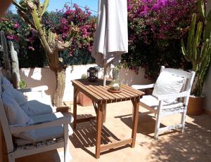 a table and two chairs and an umbrella on a patio at Apartamento limonero ,VUT AL 13044 in Albox