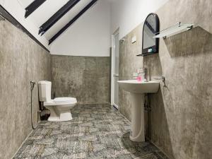 a bathroom with a toilet and a sink and a mirror at Tera Ella Boutique Hotel by SANS in Ella +36 photos