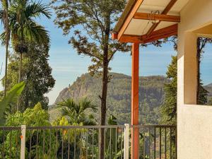 a house with a balcony with a view of a mountain at Tera Ella Boutique Hotel by SANS in Ella