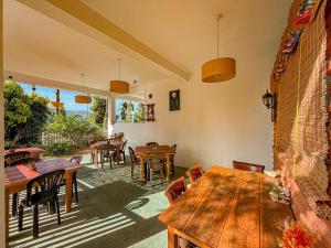 a dining room with wooden tables and chairs at Tera Ella Boutique Hotel by SANS in Ella