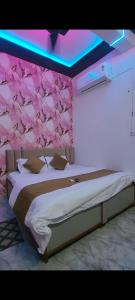 a bedroom with a bed with a pink ceiling at Hotel Vanilla inn in Bilāspur
