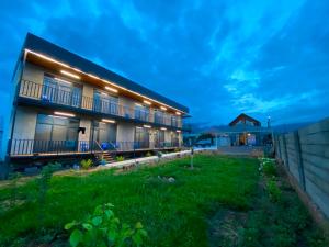 a house with a lawn in front of it at Elida Guest Rooms in Cholpon-Ata