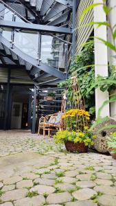 a patio with a bench and flowers in front of a building at Traditions - Hotel "Zur Tanne" in Wernigerode