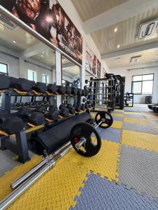 a gym with a bunch of equipment in a room at The New Taiwan Hotel in Nyanhemwa