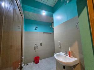 a bathroom with a sink and a shower at Hotel Pohor Regency 10 minutes travel to Kamakhya Temple in Guwahati +101 photos