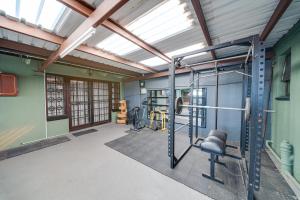 an empty gym with a treadmill and a bike in a room at 22 on Nicol in Secunda