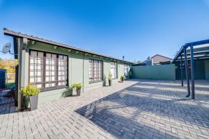 a building with a brick driveway next to a building at 22 on Nicol in Secunda