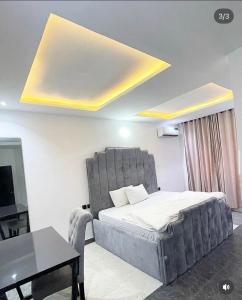 a bedroom with a large bed and a table at Homelands in Port Harcourt