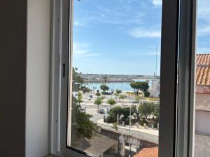 a window with a view of a city at The Arade Riverview in Portimão