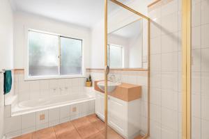 a bathroom with a tub and a sink at The Lakeview in Lilydale +41 photos