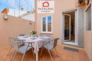 a table and chairs on the patio of a building at Casa Norai in Palamós