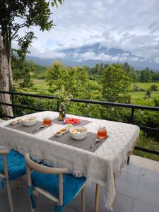 a table with plates of food on top of a balcony at De Napa - Private Homestay in Ban Mae Na