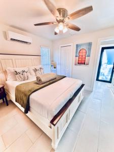 a bedroom with a large bed and a ceiling fan at The Miami Grove Oasis in Miami +80 photos