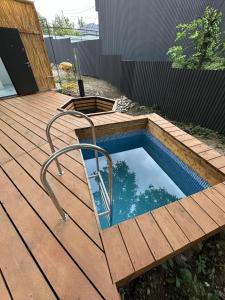a small pool on a wooden deck with a poolvisor at Отдых у речки in Almaty