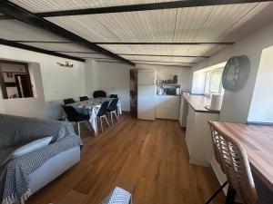 a kitchen and a living room with a table and chairs at Las Tres Patas Complejo Rural in Enix