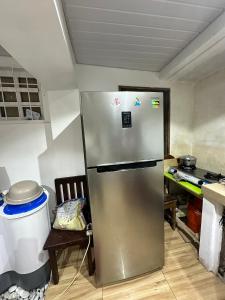 a kitchen with a stainless steel refrigerator in a room at A.C. Asistin Transient House in Baguio