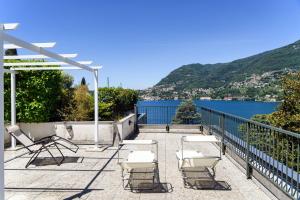 a patio with chairs and a view of the water at Il Sogno di Angelo - Blevio in Blevio