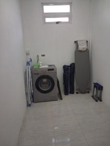 a laundry room with a washing machine in it at Palm Creek Villa in Mont Choisy