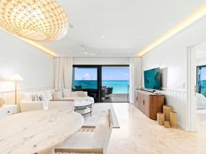 a living room with a table and a view of the ocean at La Sirène in Simpson Bay