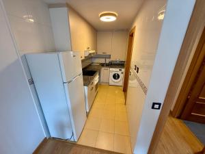 a kitchen with a refrigerator and a stove at Lotila Flats Oviedo in Oviedo +1 photo