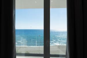 a view of the ocean from a window at White Amfora Hotel in Shëngjin
