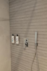 a bathroom with two soap bottles on the wall at White Amfora Hotel in Shëngjin