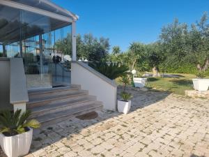 a house with stairs and potted plants in front of it at Rosmat's house in Conversano