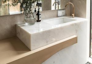 a large white sink in a bathroom with a mirror at Hotel Fairmounts Plaza Near IGI International Airport Delhi in New Delhi