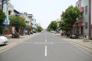 an empty street in a city with motorcycles parked on the street at Radhe Krishna Guest House in Srīrangam