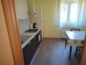 a small kitchen with a stove and a table at Apartma Z in Koper