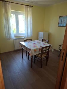 a dining room with a table and two chairs at Apartma Z in Koper