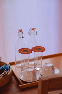 two glass bottles sitting on top of a table at Enjipai Ngorongoro Lodge in Karatu